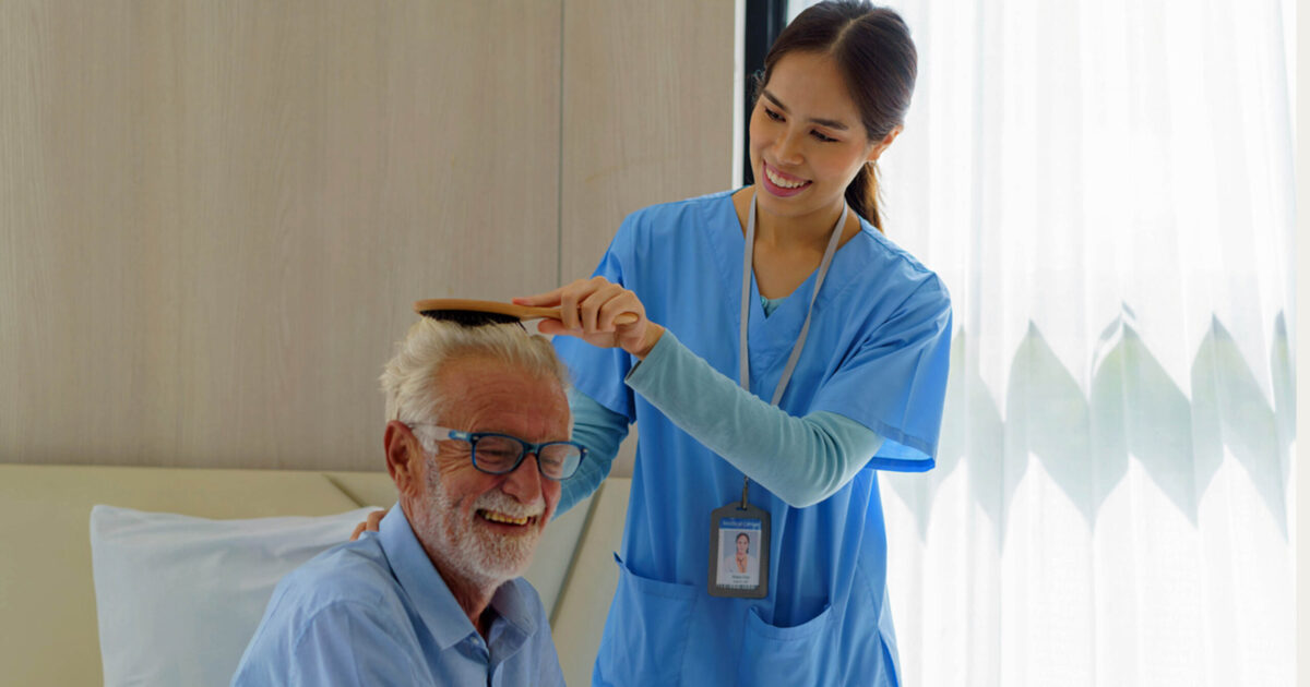 CNA assisting an elderly patient in a nursing home or at home