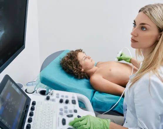 Sonography tech or ultrasound tech with young patient