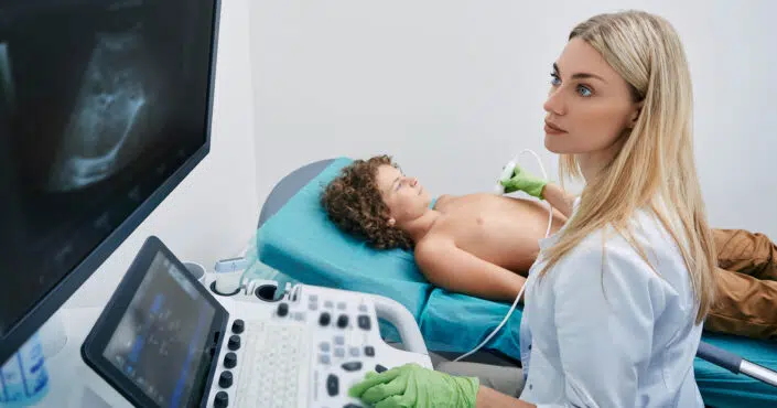 Sonography tech or ultrasound tech with young patient