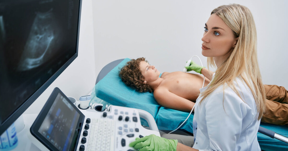 Sonography tech or ultrasound tech with young patient