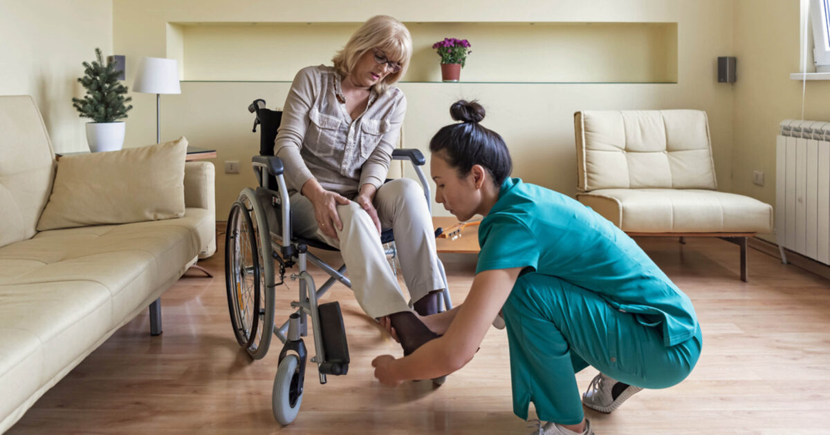 CNA or HHA helping with shoes in patient's home