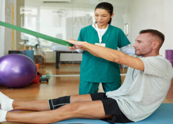 Physical therapist working patient to strengthen injured knee