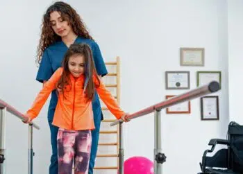 Physical therapist working with young patient