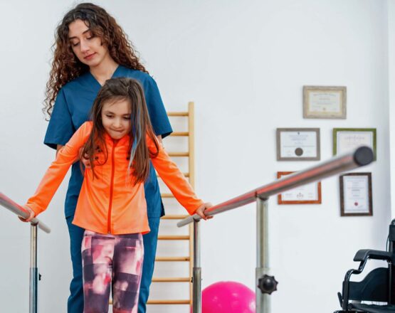 Physical therapist working with young patient