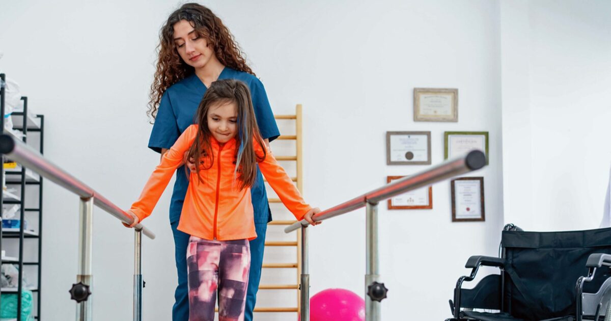 Physical therapist working with young patient